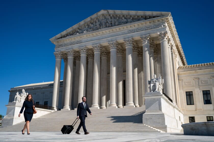 WASHINGTON, DC - NOVEMBER 01: Julie Murray, attorney with Planned Parenthood, center, and Marc Hearron, attorney representing the Texas abortion clinics, right, arrive for a news conference with members of the press outside the Supreme Court of the United States on Monday, Nov. 1, 2021 in Washington, DC. On Monday, Nov. 1, the Supreme Court heard arguments in a challenge to the controversial Texas abortion law that bans abortions after 6 weeks. (Kent Nishimura / Los Angeles Times)