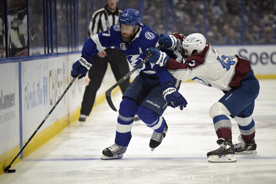 Tampa Bay Lightning defenseman Victor Hedman (77) controls the puck next to Colorado Avalanche center Darren Helm (43) during the second period of Game 6 of the NHL hockey Stanley Cup Finals on Sunday, June 26, 2022, in Tampa, Fla. (AP Photo/Phelan Ebenhack)