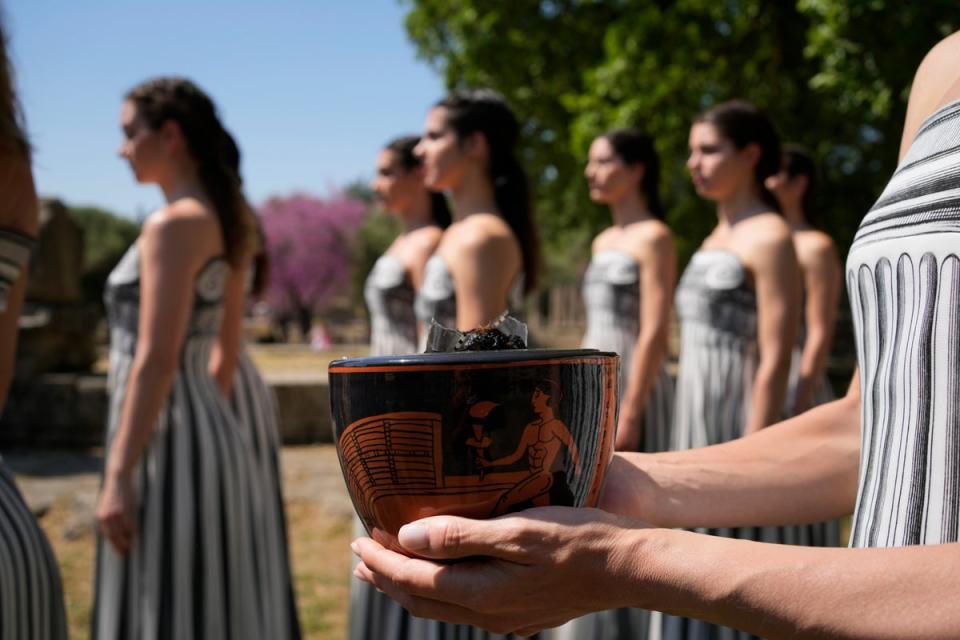 A performer holds the new ceramic pot, that was used at the lighting ceremony for the Paris Olympics (AP)