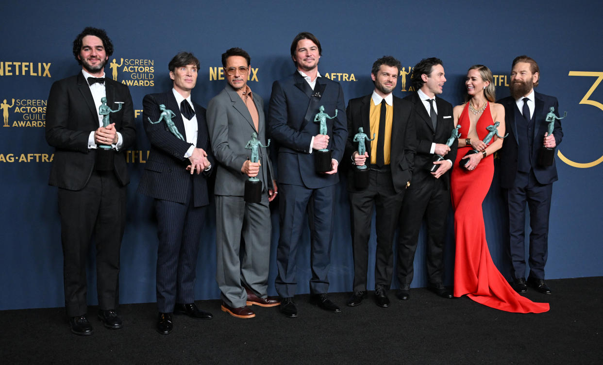 (L-R) Benny Safdie, Cillian Murphy, Robert Downey Jr., Josh Hartnett, Alden Ehrenreich, Casey Affleck, Emily Blunt and Kenneth Branagh, winner of the Outstanding Performance by a Cast in a Motion Picture award for 'Oppenheimer' pose in the press room during the 30th Annual Screen Actors Guild Awards at the Shrine Auditorium in Los Angeles, February 24, 2024. (Photo by Robyn BECK / AFP) (Photo by ROBYN BECK/AFP via Getty Images)