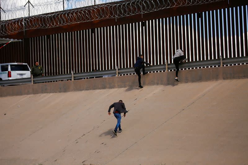 Asylum-seeking migrants walk out of the Rio Bravo river after crossing it to turn themselves in to U.S. Border Patrol agents to request asylum in El Paso, Texas, U.S., as seen from Ciudad Juarez