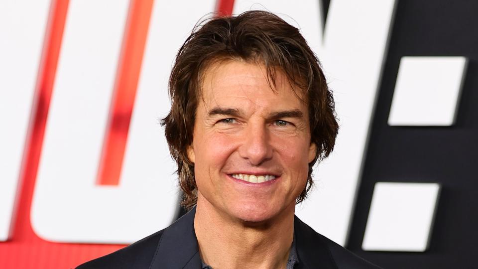 tom cruise smiling on the red carpet of the mission impossible new york premiere