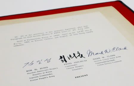 The signatures of North Korea's Supreme Army Commander and Leader Kim Il Sung, grandfather of current North Korea Leader Kim Jong-un, along with signatories from China and the United Nations, are seen on the original English language copy of the armistice agreement that ended the fighting between North and South Korea when signed on July 27, 1953 as it is displayed in a conservation lab of the U.S. National Archives in Adelphi, Maryland near Washington, U.S., June 4, 2018. REUTERS/Jim Bourg/Files