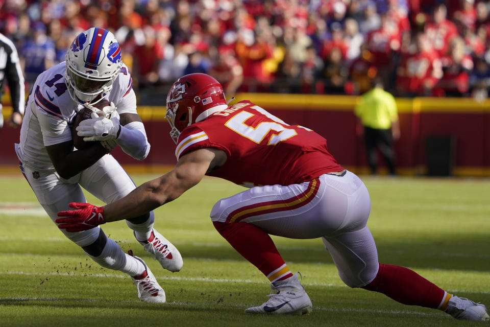 Buffalo Bills wide receiver Stefon Diggs (14) runs with the ball as Kansas City Chiefs linebacker Leo Chenal defends during the first half of an NFL football game Sunday, Oct. 16, 2022, in Kansas City, Mo. (AP Photo/Ed Zurga)