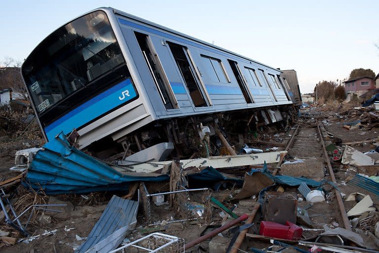 A wrecked train carriage lies beside the tracks in Higashimatsushima, Miyagi prefecture. Workers at Japan's crippled nuclear plant Sunday struggled to stop a radioactive water leak into the Pacific, as the government warned the facility may spread contamination for months