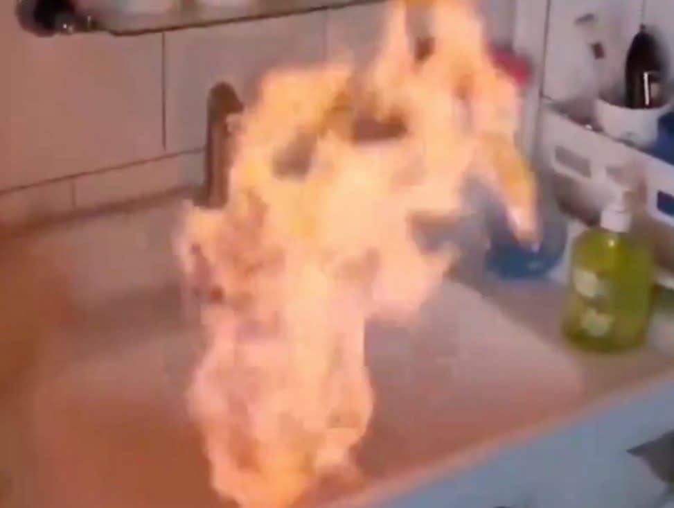 Tap water being set on fire in China (Screengrab/People’s Daily)