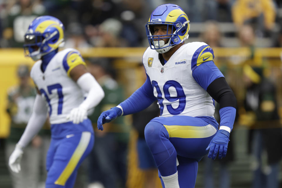 Los Angeles Rams defensive tackle Aaron Donald, right, warms up before an NFL football game against the Green Bay Packers, Sunday, Nov. 5, 2023, in Green Bay, Wis. (AP Photo/Matt Ludtke)