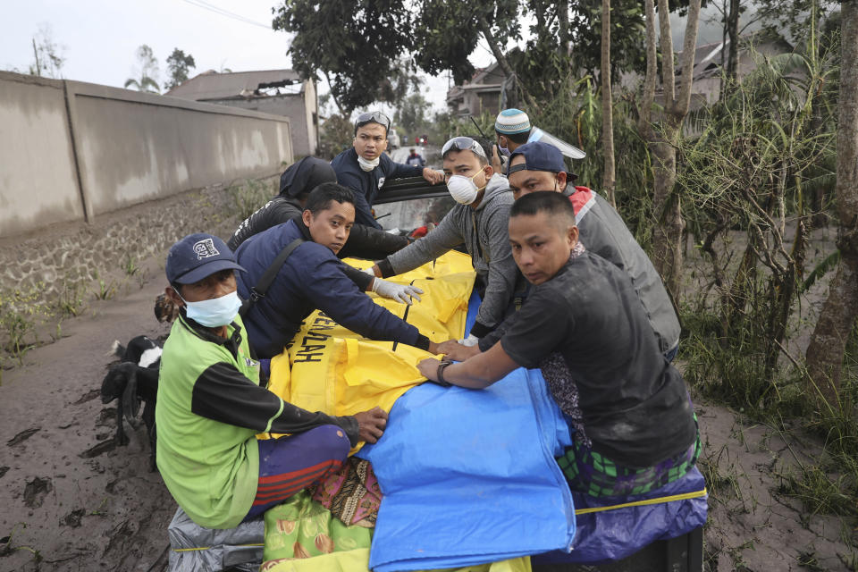 Indonesian rescuers and villagers evacuate a victim on a car in an area affected by the eruption of Mount Semeru in Lumajang, East Java, Indonesia, Sunday, Dec. 5, 2021. The highest volcano on Indonesia’s most densely populated island of Java spewed thick columns of ash, searing gas and lava down its slopes in a sudden eruption triggered by heavy rains on Saturday. (AP Photo/Trisnadi)