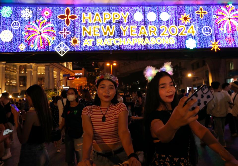 Thai women take selfie photographs to celebrate the New Year’s Eve in Bangkok (EPA)