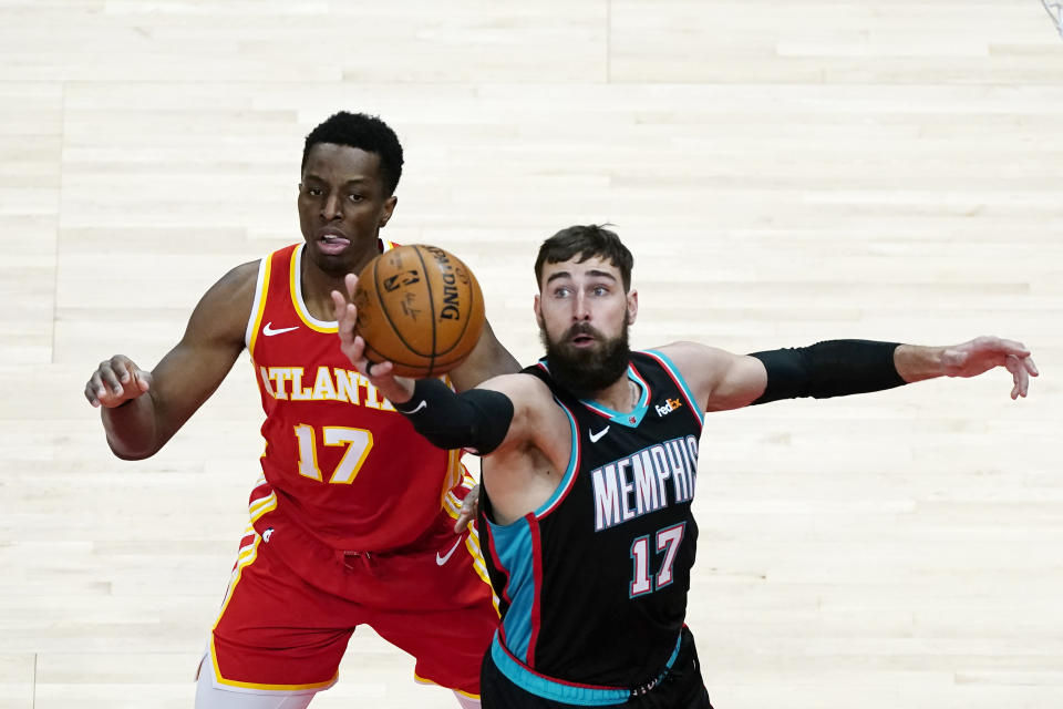 Memphis Grizzlies center Jonas Valanciunas (17) grabs a rebound in front of Atlanta Hawks forward Onyeka Okongwu (17) in the first half of an NBA basketball game Wednesday, April 7, 2021, in Atlanta. (AP Photo/John Bazemore)