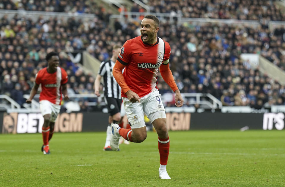 Luton Town's Carlton Morris celebrates scoring their side's third goal of the game from the penalty spot during the English Premier League soccer match between Newcastle and Luton Town at St. James' Park, Newcastle upon Tyne, England, Saturday, Feb. 3, 2024. (Owen Humphreys/PA via AP)
