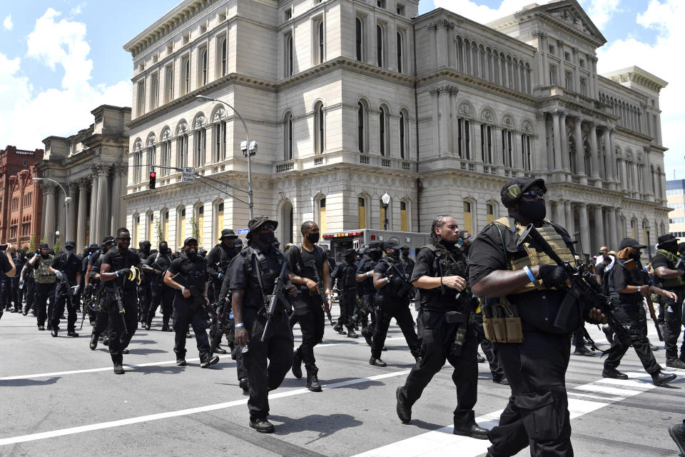 Armed members of the "NFAC" march through downtown Louisville, Ky., toward the Hall of Justice on Saturday, July 25, 2020. Hundreds of activists demanded justice for Breonna Taylor during the demonstrations in her hometown that drew counter-protesters from a white militia group. Taylor, a 26-year-old EMT, was fatally shot when police officers burst into her Louisville apartment using a no-knock warrant during an investigation. (AP Photo/Timothy D. Easley)