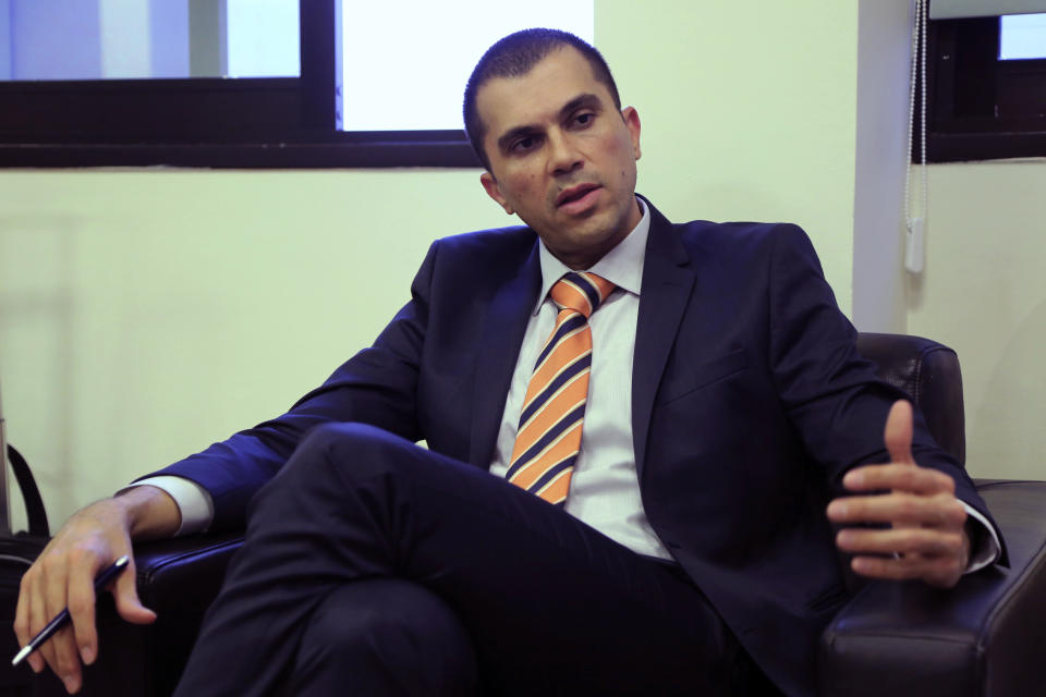 Cyprus' deputy minister of tourism Savvas Perdios speaks with the Associated Press during an interview at his office in Nicosia, Cyprus, Wednesday, Nov. 13, 2019. Perdios says his organization is teaming up with Israeli authorities to jointly promote the east Mediterranean as prime cruise line holiday destination. (AP Photo/Petros Karadjias)