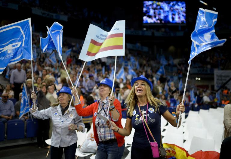 Supporters wave flags during the ruling conservative Popular Party (PP)'s closing campaign meeting in Madrid on May 22, 2015