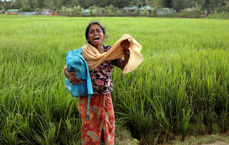 Taslima, 20, a Rohingya refugee woman who fled from Myanmar, cries because her father died while crossing the border, in Palang Khali, Bangladesh October 16, 2017. REUTERS/ Zohra Bensemra