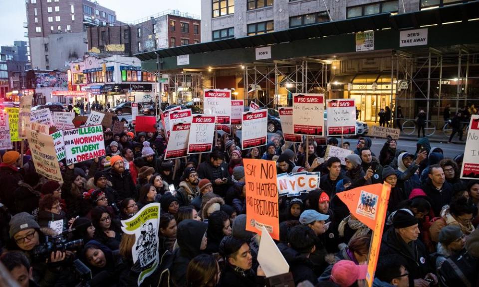 Immigrants and their supporters rally outside a court during a protest against recent immigration raids in New York