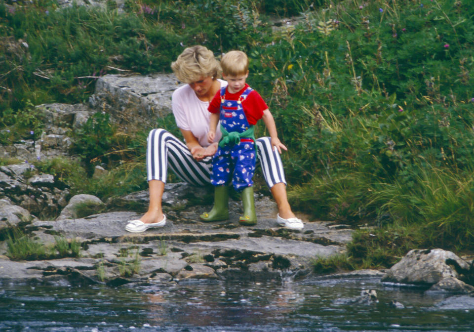 BALMORAL, SCOTLAND  -  AUGUST 18:   Diana, Princess of Wales, and Prince Harry play on the banks of the River Dee, near Balmoral Castle.during a Summer vacation, on August 18, 1987, in Balmoral, Scotland. (Photo by Julian Parker/UK Press via Getty Images)