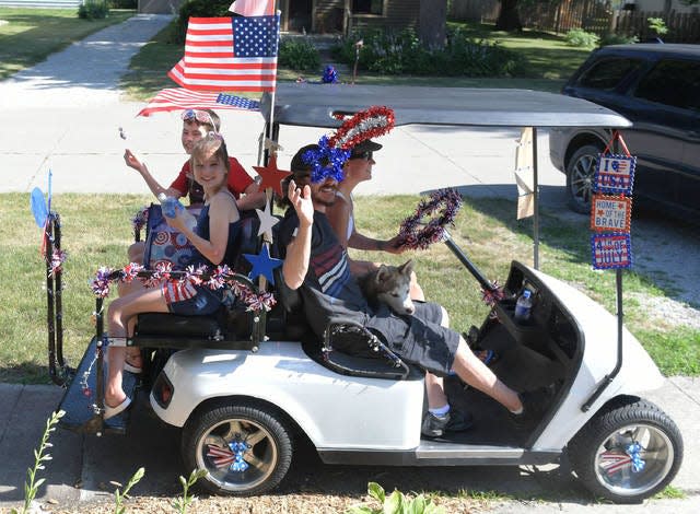 Residents of Slater drive a decorated cart around the Slater area during the town’s Fourth of July celebration.