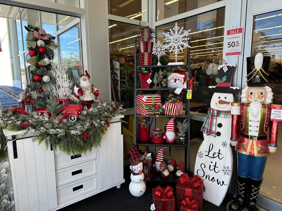 Christmas decoration display at a craft store with snowman, nutcracker, and garland