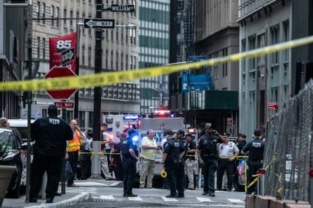 New York City Police Department officers are seen near the Fulton Street subway station as police said they were investigating two suspicious packages in Manhattan