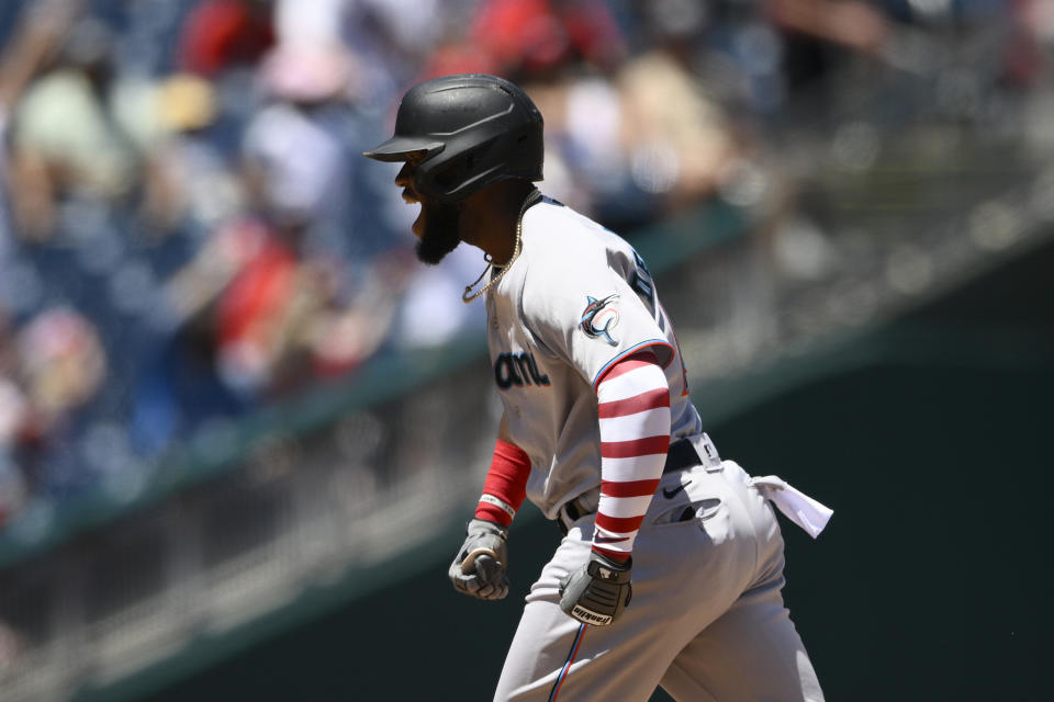 Miami Marlins' Bryan De La Cruz celebrates his two-run home run as he rounds the bases during the 10th inning of a baseball game against the Washington Nationals, Monday, July 4, 2022, in Washington. The Marlins won 3-2 in ten innings. (AP Photo/Nick Wass)