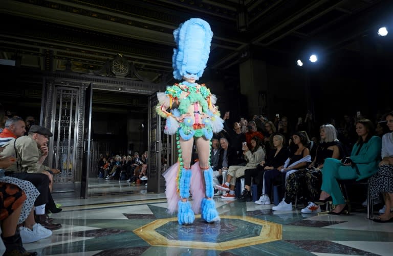 British designer Pam Hogg arguably stole the show by parading a collection of extravagant multicolored tulle hats worn over bright uniforms