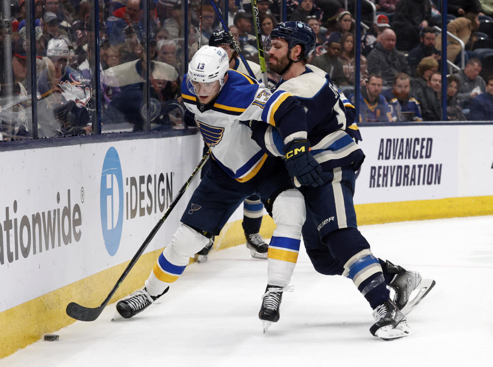 Columbus Blue Jackets forward Boone Jenner, right, checks St. Louis Blues forward Alexey Toropchenko during the second period of an NHL hockey game in Columbus, Ohio, Saturday, March 11, 2023. (AP Photo/Paul Vernon)