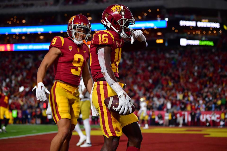 Southern California wide receiver Tahj Washington (16) celebrates his touchdown during the first half against Notre Dame at the Los Angeles Memorial Coliseum.