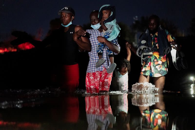 Migrantes que buscan asilo en Estados Unidos cruzan el río Grande cerca del Puente Internacional entre México y Estados Unidos, en Ciudad Acuña, México