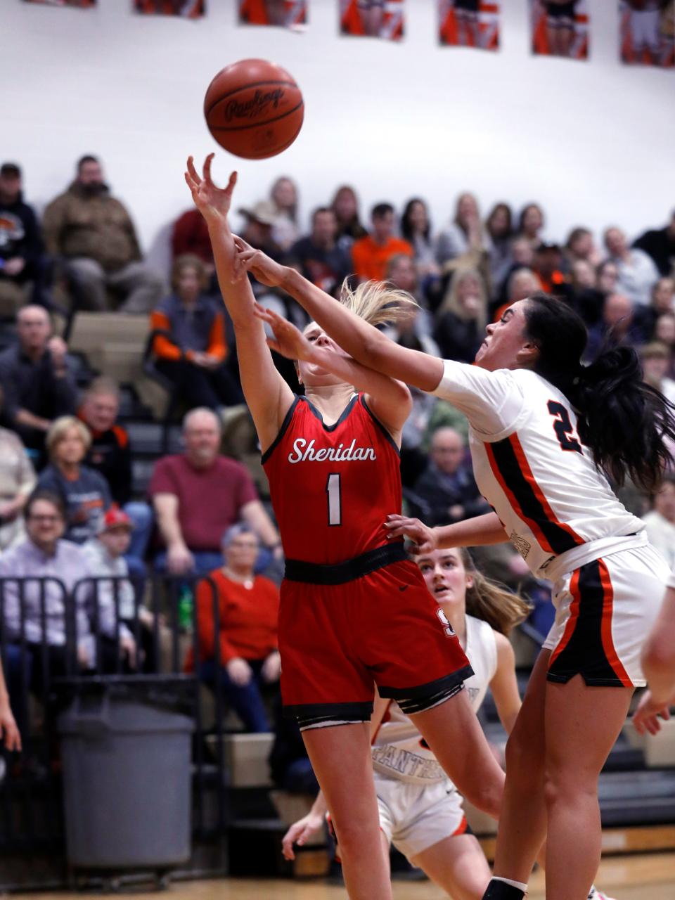 Sheridan's Jamisyn Stinson shoots in the lane against New Lexington's Aubri Spicer in a regular season game. Both were District 12 First-Team selections.