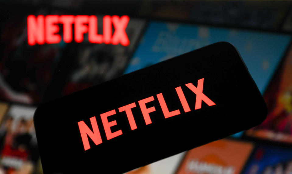 Netflix logo displayed on a phone screen and Netflix website displayed on a laptop screen are seen in this photo illustration.