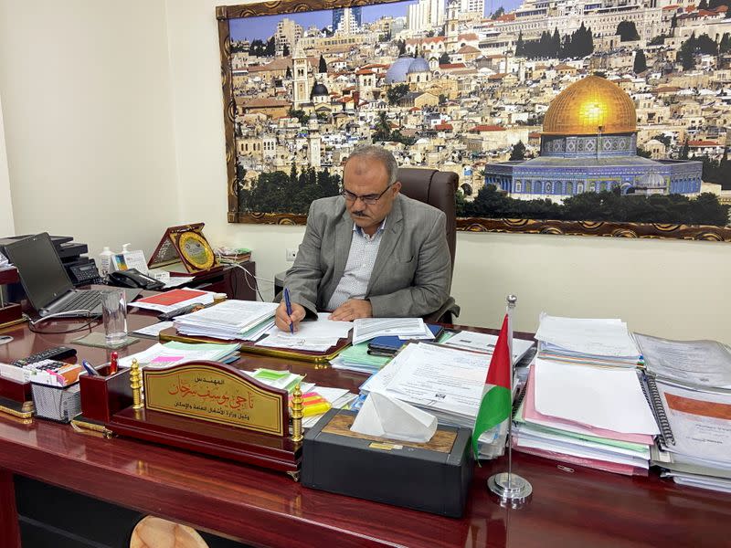 Palestinian Naji Sarhan, Deputy Minister of Housing and Public Works in Gaza, works at his office in Gaza