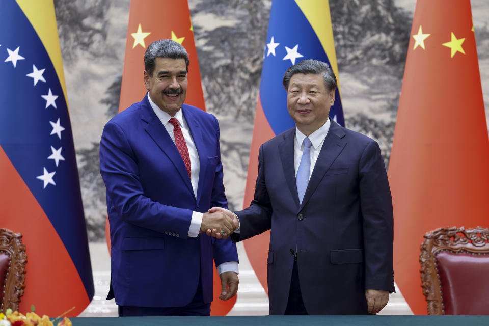 In this photo released by Xinhua News Agency, visiting Venezuela's President Nicolas Maduro, left, shakes hands with his Chinese counterpart Xi Jinping during a meeting at the Great Hall of the People in Beijing, Wednesday, Sept. 13, 2023. (Liu Bin/Xinhua via AP)