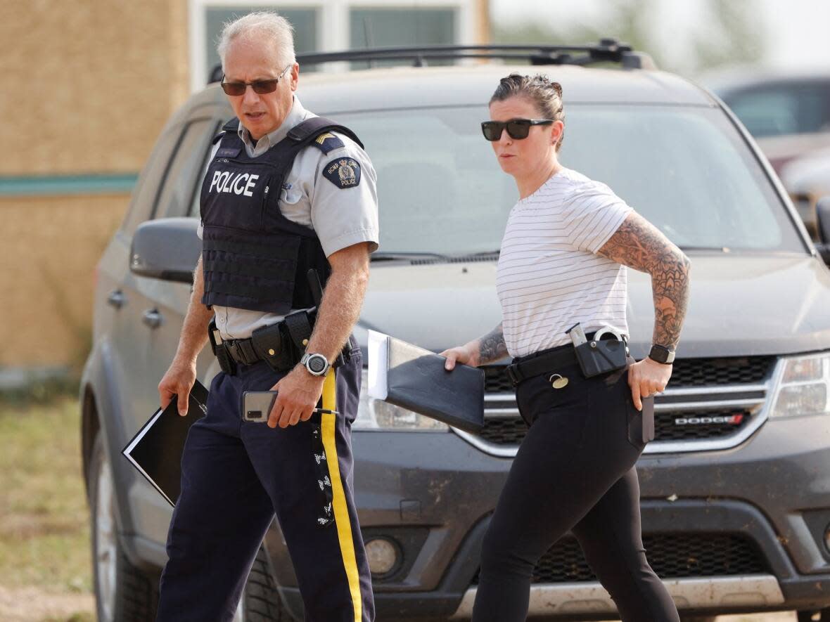 RCMP officers are seen at James Smith Cree Nation on Sept. 5, 2022, after multiple people were killed and injured. The main suspect, Myles Sanderson, died later in RCMP custody and his death is being investigated by the Saskatoon Police Service in co-operation with the Serious Incident Response Team. (David Stobbe/Reuters - image credit)