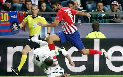 Real Madrid's Sergio Ramos, left, and Atletico's Diego Costa challenge for the ball during the UEFA Super Cup final soccer match between Real Madrid and Atletico Madrid - Credit: AP