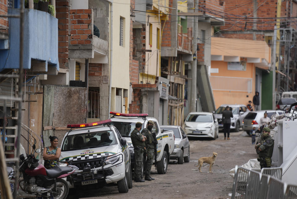 Policemen patrol in the Paraisopolis favela, during the community's centennial celebration, in Sao Paulo, Brazil, Thursday, Sept. 16, 2021. One of the largest favela's in Brazil, home to tens of thousands of residents in the country's largest and wealthiest city, Paraisopolis is grappling with crime and a pandemic that have challenged daily life for many who live there, but organizers say its people have built a vibrant community and are launching a 10-day celebration of its achievements. (AP Photo/Andre Penner)