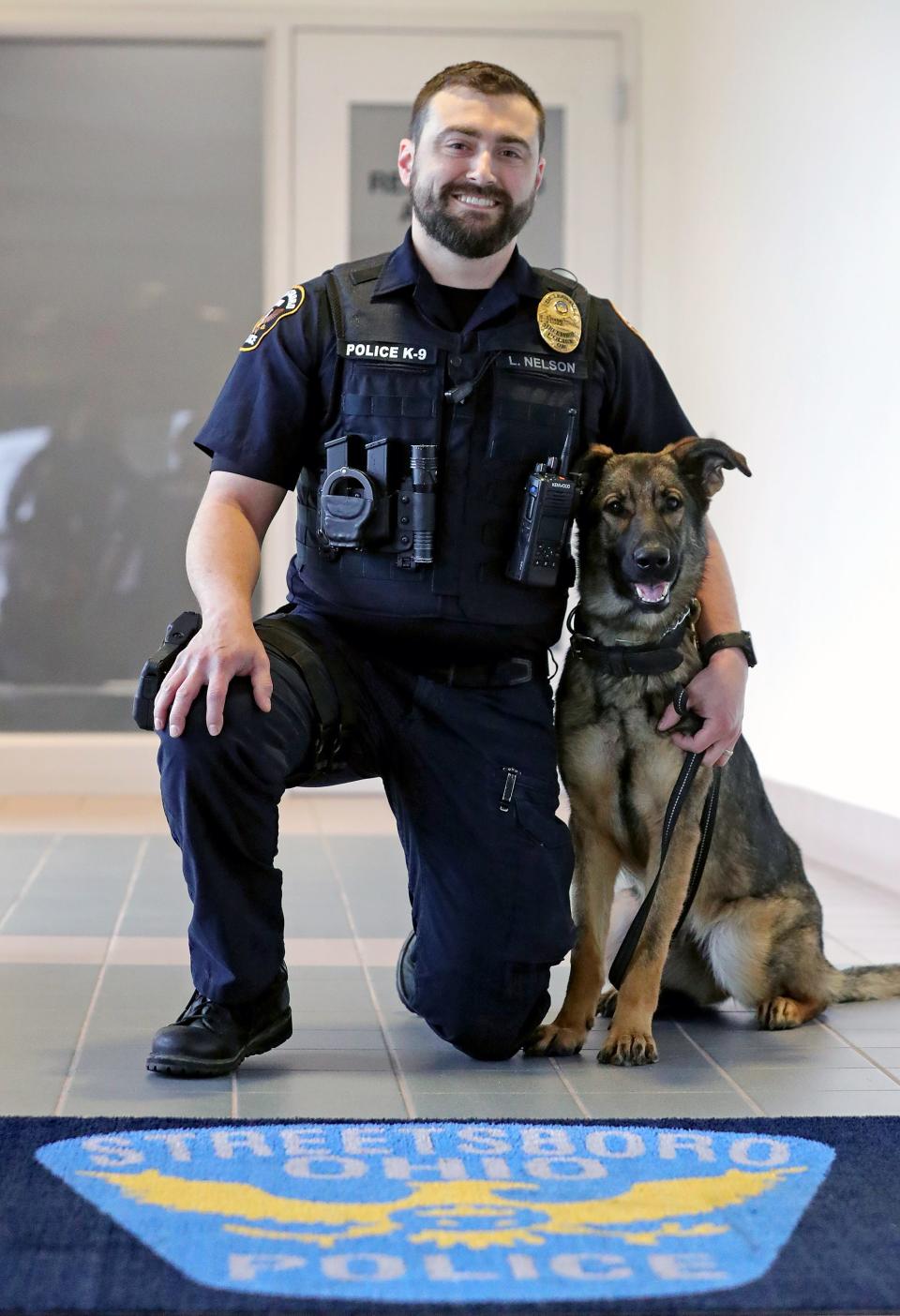 Streetsboro Police Detective Luke Nelson poses for a photo with his partner Mika at the station, Tuesday, April 2, 2024, in Streetsboro.