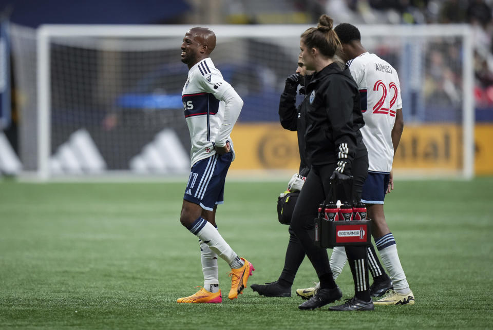 Vancouver Whitecaps' Fafa Picault, left, leaves the pitch after being injured during the first half of the team's MLS soccer match against the LA Galaxy on Saturday, April 13, 2024, in Vancouver, British Columbia. (Darryl Dyck/The Canadian Press via AP)