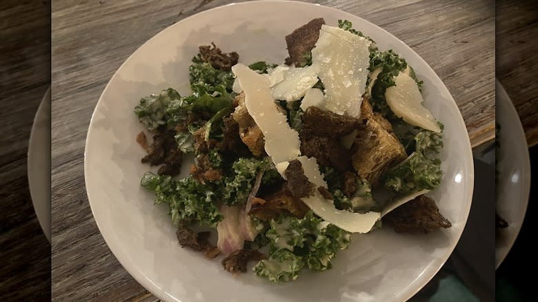 kale salad with croutons and Parmesan shavings