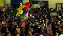 Residents wave the Ethiopian and Eritrean national flags as they dance during a concert at the Millennium Hall in Addis Ababa, Ethiopia July 15, 2018. REUTERS/Tiksa Negeri