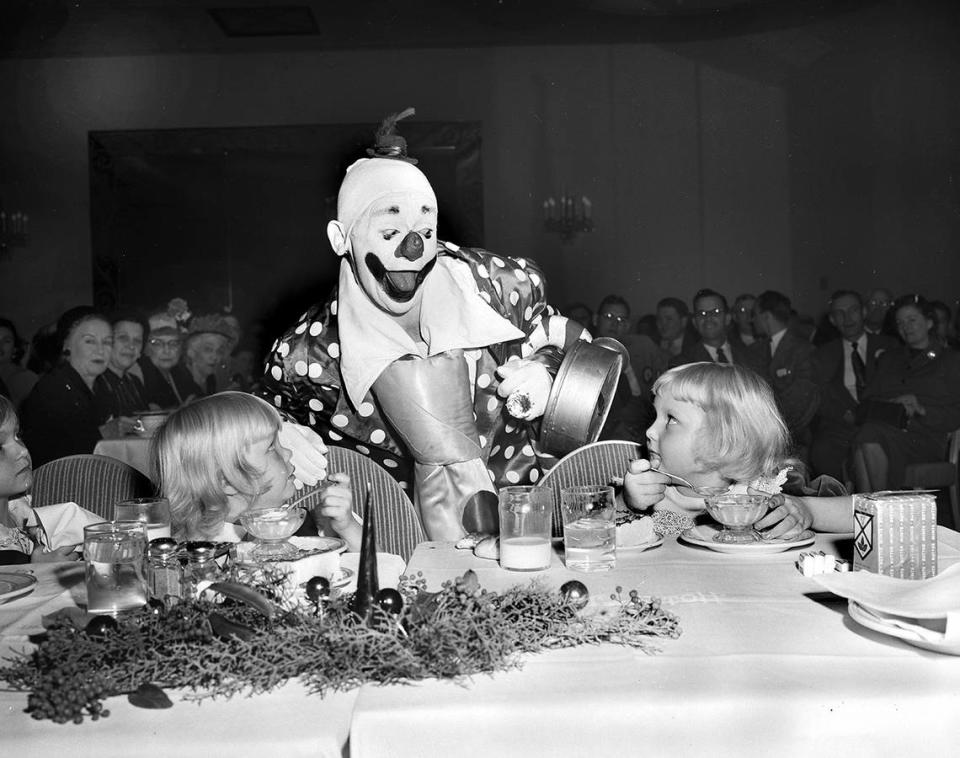 Dec. 23, 1952: Second only to Santa Claus at the All Church Home party given by the Lions Club was Paul Jung, world-famous clown, flanked by Linda Gail Adams, 4, left, and Rita Lemmer, 4.