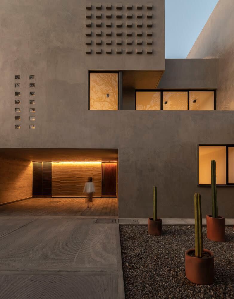 Woman walks through an entryway in Oaxaca's Espacio 18-designed 