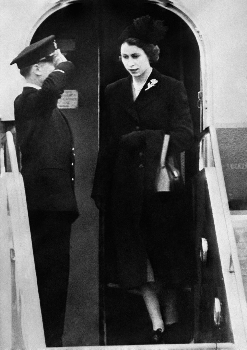 Dressed in black Queen Elizabeth II sets foot on British soil for the first time since her accession as she lands at London Airport after her day and night flight from Kenya following the death of her father, King George VI.   (Photo by PA Images via Getty Images)