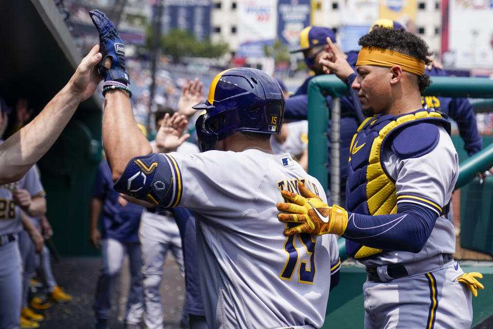 Milwaukee Brewers' Tyrone Taylor, left, celebrates his solo home run with his teammates during the second inning of a baseball game against the Washington Nationals at Nationals Park, Wednesday, Aug. 2, 2023, in Washington. (AP Photo/Alex Brandon)