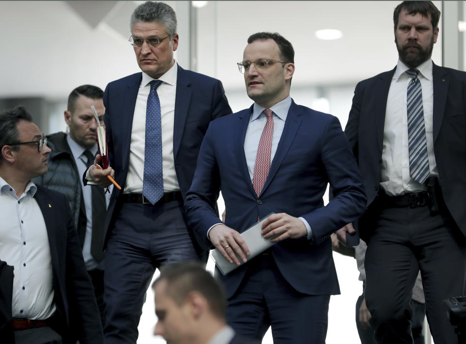 File - In this Thursday, March 26, 2020 file photo, Lothar H. Wieler, president of the Robert-Koch-Institute, top left, and German Health Minister Jens Spahn of the Christian Democratic Union, CDU, party, top center, leave after a press conference in Berlin, Germany, on the fight against the new coronavirus outbreak. German Chancellor Angela Merkel's center-right party, the Christian Democratic Union, CDU, is choosing a new leader on the weekend Saturday Jan. 16 and Sunday Jan. 17, 2021, a decision that will help determine who succeeds Merkel at the helm of the European Union's biggest economy after a 16-year reign. (AP Photo/Michael Sohn, file)