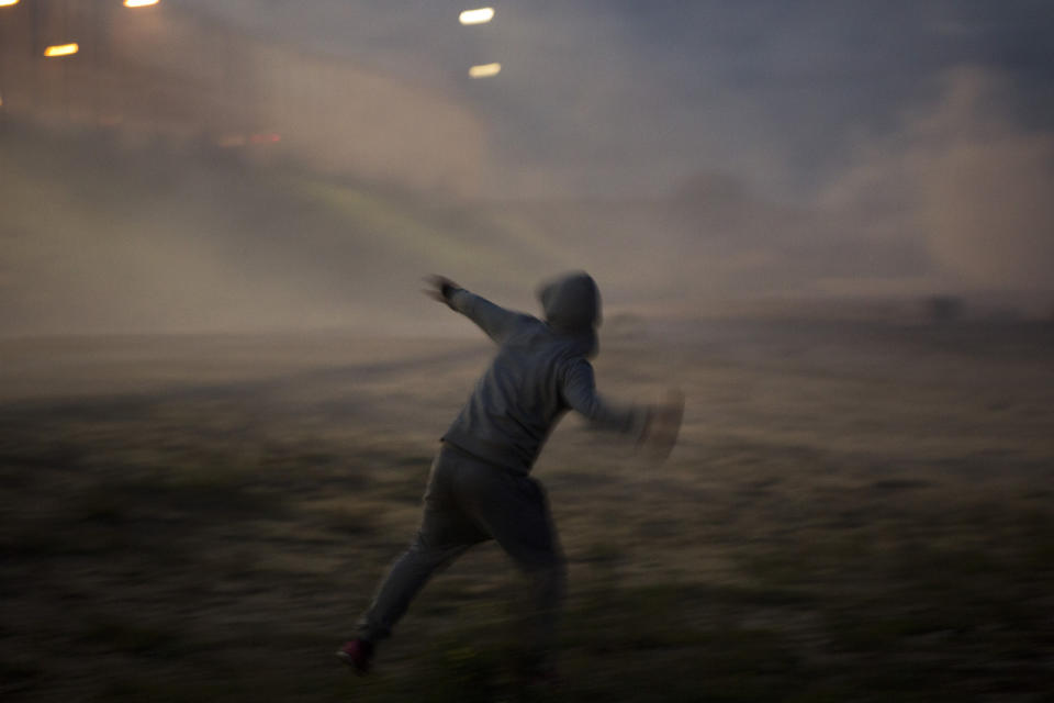 A man prepares to throw a projectile during the clashes. 