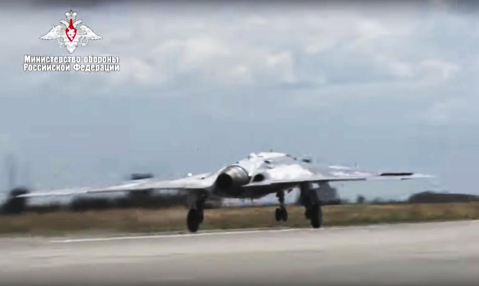 In this video grab made available on Wednesday, Aug. 7, 2019, by Russian Defense Ministry Press Service, Russia's military drone Okhotnik is seen taking off at an unidentified location in Russia. The ministry said the drone, which has stealth capabilities and is equipped with advanced reconnaissance equipment, made its maiden flight Saturday. (Russian Defense Ministry Press Service via AP)