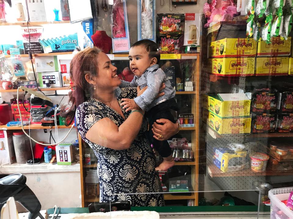 Sabitra Phuyel, owner of Nepali Dumpling House in Burlington, Vt., holds her 7-month-old son, Prayash. The Nepali Dumpling House will close at the end of August after nearly four years because of a steep decline in business during the COVID-19 pandemic.