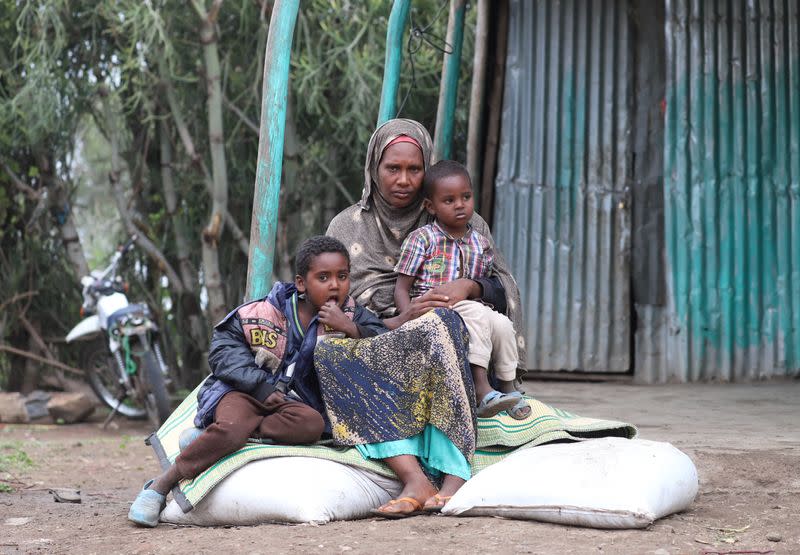 Internally displaced Ethiopian sits on bags of rotten wheat which was ruined by heavy rain and desert locusts, Tuli Guled, Somali Region