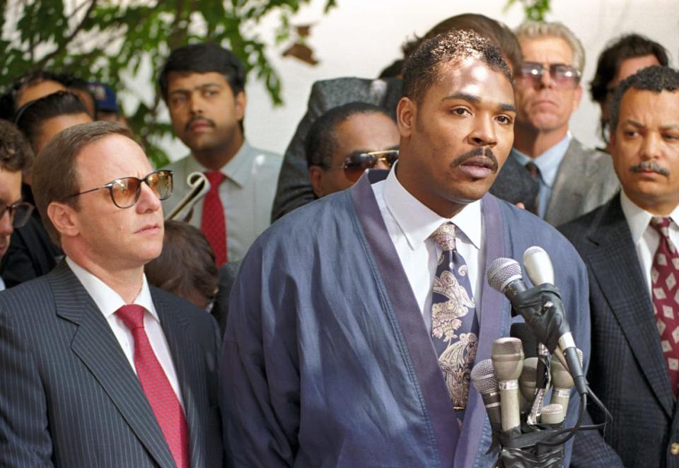 <div class="inline-image__caption"><p>Rodney King delivers an emotional appeal May 1, 1992 calling for an end to rioting in Los Angeles after a jury acquitted four Los Angeles police officers in his videotaped beating. King is joined by his attorney Steve Lerman.</p></div> <div class="inline-image__credit">Lou Dematteis/Getty Images</div>